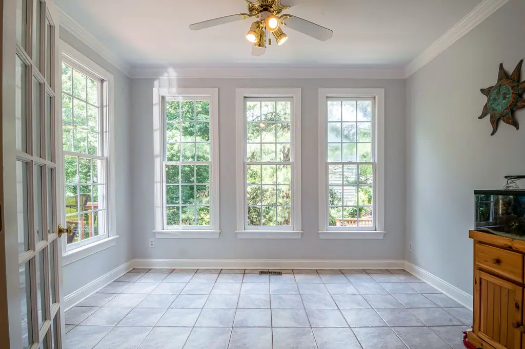 Florida room with three tall windows letting in strong daylight